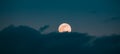 Full Moon Rising In Cloudy Evening Sky Royalty Free Stock Photo
