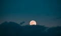 Full Moon Rising In Cloudy Evening Sky Royalty Free Stock Photo