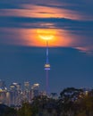 Full moon rising over the CN Tower and Toronto skyline on a hazy evening