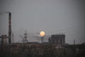 Full moon rising over industrial landscape Royalty Free Stock Photo