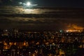 Full moon rising over night skyline of city Royalty Free Stock Photo