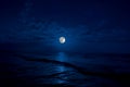 Full moon rising over sea at night with copy space. big full moon reflecting in a sea. Azerbaijan Royalty Free Stock Photo