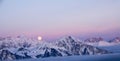 Full moon rising over a winter mountain landscape Royalty Free Stock Photo