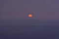 Full moon sea. The supermoon is orange in a purple sky over the ocean Royalty Free Stock Photo