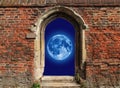 Full moon seen with telescope beneath a wall
