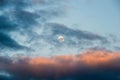 Full moon, slowly floating red clouds illuminated by the sun Royalty Free Stock Photo