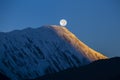 Full moon during a sunrise on the background of snow-capped in Himalayas mountains in Nepal Royalty Free Stock Photo