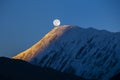 Full moon during a sunrise on the background of snow-capped in Himalayas mountains in Nepal Royalty Free Stock Photo