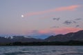 Full moon at sunset in mountain range in New Zealand Royalty Free Stock Photo
