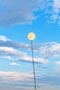 Full moon tied on chain soars into blue sky