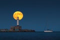 Full moon twilight landscape over sea horizon, sailing yacht boat and lighting lighthouse beacon from the bay