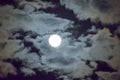 Beautiful full moon and white cloudy sky background in the midnight sky background, moonlight on Halloween night without stars. Royalty Free Stock Photo