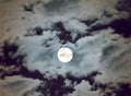 Beautiful full moon and white cloudy sky background in the midnight sky background, moonlight on Halloween night without stars. Royalty Free Stock Photo