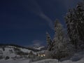 Full moon winter night fairytale, mountains and a village in the distance Royalty Free Stock Photo