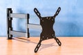 Full Motion TV Monitor Wall Mount Bracket Articulating Arms Swivels Tilts Extension Rotation, on the wooden table. 3D rendering