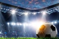 Full night football arena in lights with ball close up Royalty Free Stock Photo