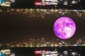 full oak moon and night lights of pier and beach and abstract reflection city onthe sky