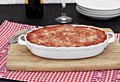 Full oval white baking pan of baked eggplant or lasagna.