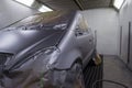 Full painting of a silver car in the back of a hatchback, some p