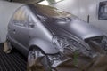 Full painting of a silver car in the back of a hatchback, some p