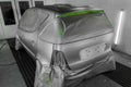 Full painting of a silver car in the back of a hatchback, some p