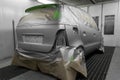 Full painting of a silver car in the back of a hatchback, some p