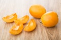 Full and pieces of ripe loquat on table