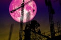 full pink moon back silhouette worker on construction building