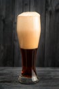 Full pint of beer on wooden background Royalty Free Stock Photo
