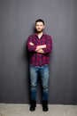 Full Portrait of handsome young man in casual shirt keeping arms crossed and smiling Royalty Free Stock Photo