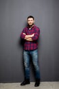 Full Portrait of handsome young man in casual shirt keeping arms crossed and smiling Royalty Free Stock Photo