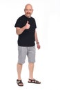 Full portrait of a man bald man in shorts doing the sign thumbs up Royalty Free Stock Photo