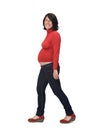 Full portrait of a pregnant woman with casual clothes walking on white background Royalty Free Stock Photo