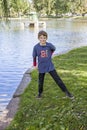 Full portrait of a smiling eight year old boy by a lake Royalty Free Stock Photo