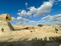 Full profile of Great Sphinx including pyramids in the background on a clear sunny, blue sky day in Giza, Cairo, Egypt with no Royalty Free Stock Photo