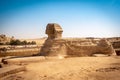 The full profile of the Great Sphinx with the pyramid in the background in Giza. Egypt. Royalty Free Stock Photo