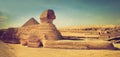 The full profile of the Great Sphinx with the pyramid in the background in Giza. Royalty Free Stock Photo
