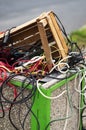 Full public outdoor trash bin with cables