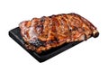 Full rack of BBQ grilled pork spare ribs on a marble board. Isolated on white background. Royalty Free Stock Photo