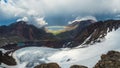 Full rainbow over a glacial mountain valley.Atmospheric alpine landscape with snowy mountains with rainbow in rainy and sunny Royalty Free Stock Photo