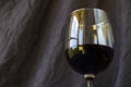 Full red wine glass on the dark and gray background Royalty Free Stock Photo