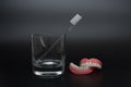 Full removable plastic denture of the jaws. Two acrylic dentures. Dental care with an toothbrush. Teeth and toothbrush