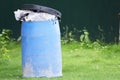 Full of rubbish blue bin at public playing park Royalty Free Stock Photo