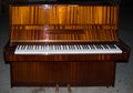 Full scale brown upright piano 88 keys keyboard. White and black keys in perspective, two pedals. Royalty Free Stock Photo