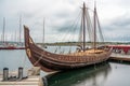full-scale viking ship docked at harbor, with sails furled and oars in place Royalty Free Stock Photo