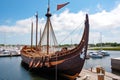 full-scale viking ship docked at harbor, with sails furled and oars in place Royalty Free Stock Photo