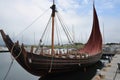 full-scale viking ship docked at harbor, with sails furled and oars in place Royalty Free Stock Photo