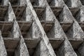 Full-screen background - fragment of the facade of a concrete dilapidated building with square cells Royalty Free Stock Photo