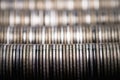 Full-screen background of horizontal stacks of silver metal coins