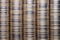 Full-screen background of silver metal coin stacks